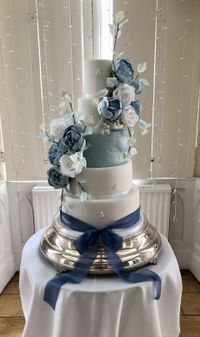 Five tiered Dusty Blue and White fondant finish with bespoke Faux flowers